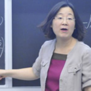 Professor writing math equations on a chalkboard