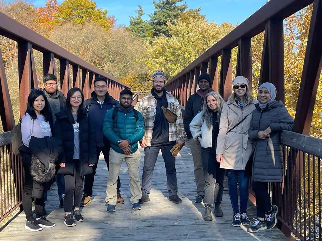 GSCAN members on a bridge in a forest while on a hike