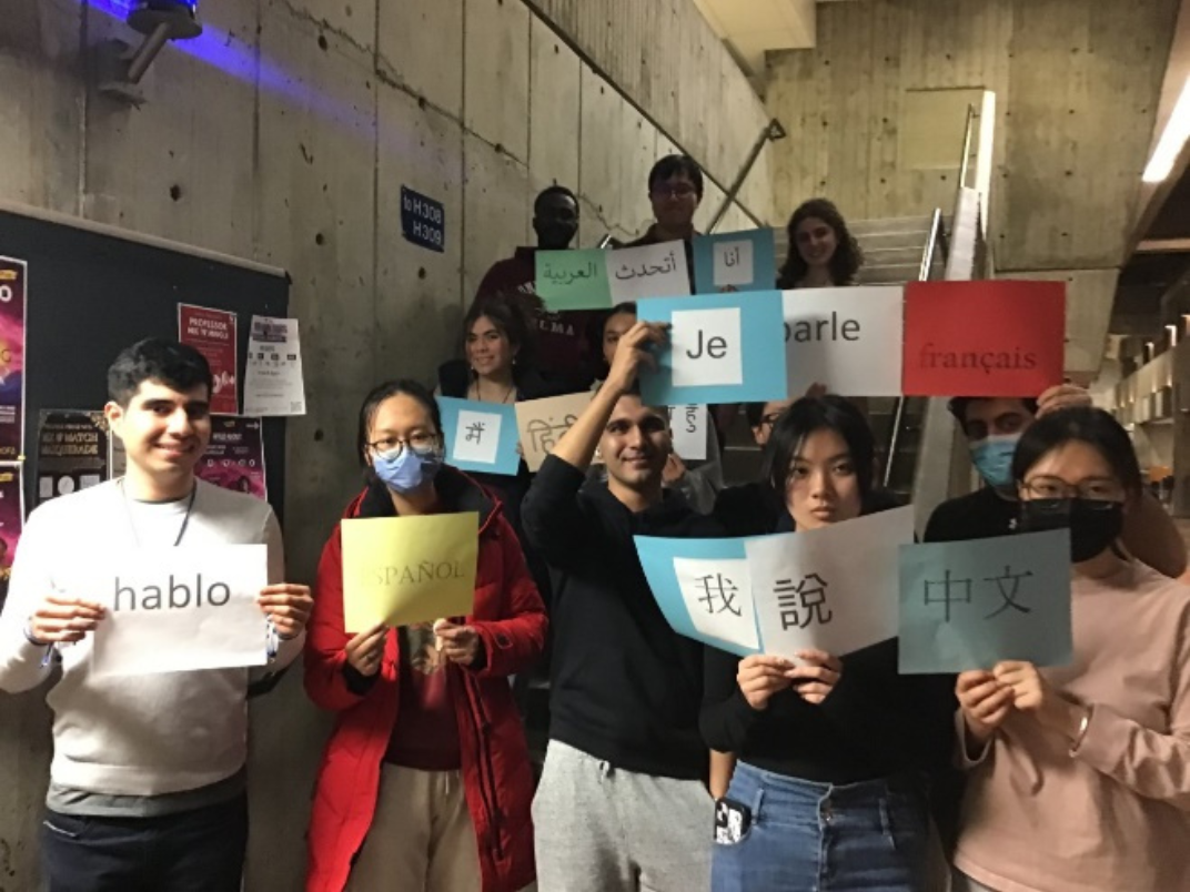 Students holding signs in various languages