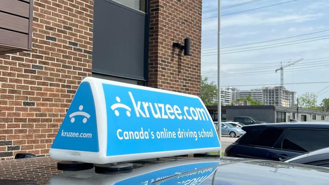 A photo of a Kruzee ad on top of a car