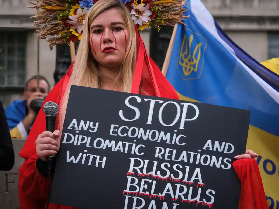 A protester in London holds up a sign asking to stop economic and diplomatic relations with Russia, Belarus and Iran Photograph: Jasmine Leung/SOPA Images/Shutterstock