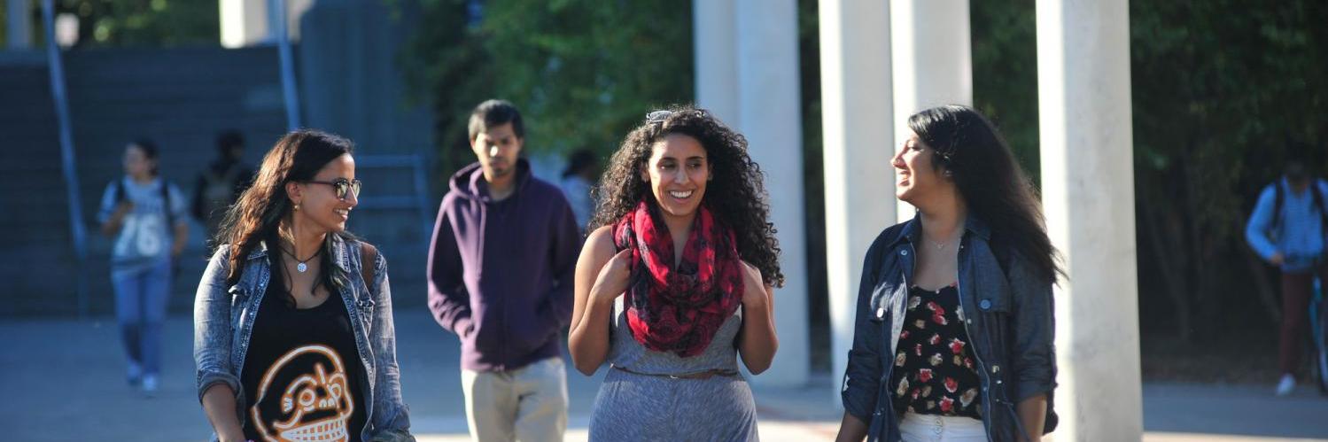 A group of students walk on campus
