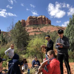 Group of students in front of a rock formation