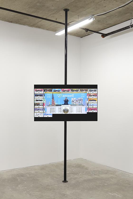 Installation of "The Racket (Automatons)", a TV floating in the middle of a pole displaying videos and images of global news