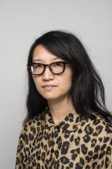 headshot of Charlene K. Lau wearing a leopard shirt and black framed glasses 