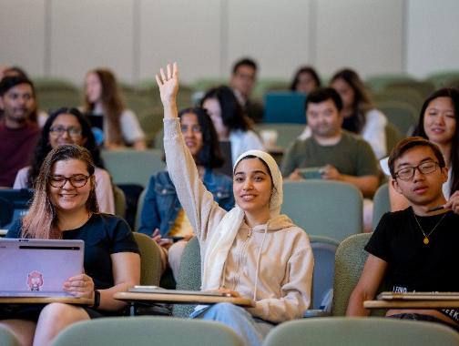 student raising hands