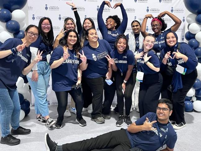 Group of Student Recruitment Assistants in front of UTSC backdrop