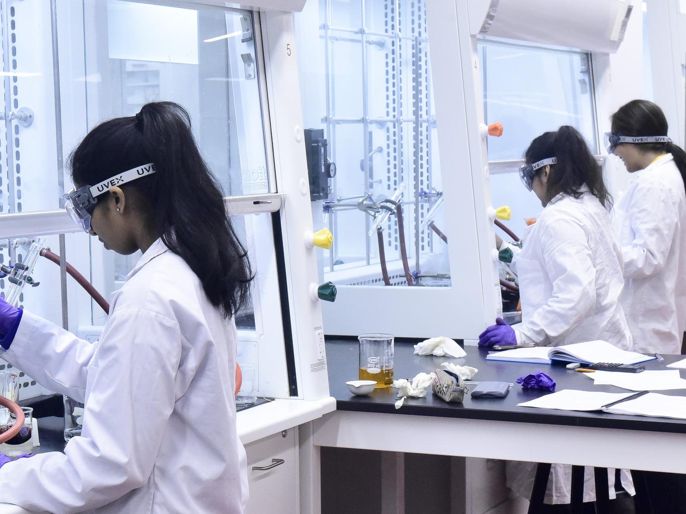 Students in a lab in front of a bank of equipment