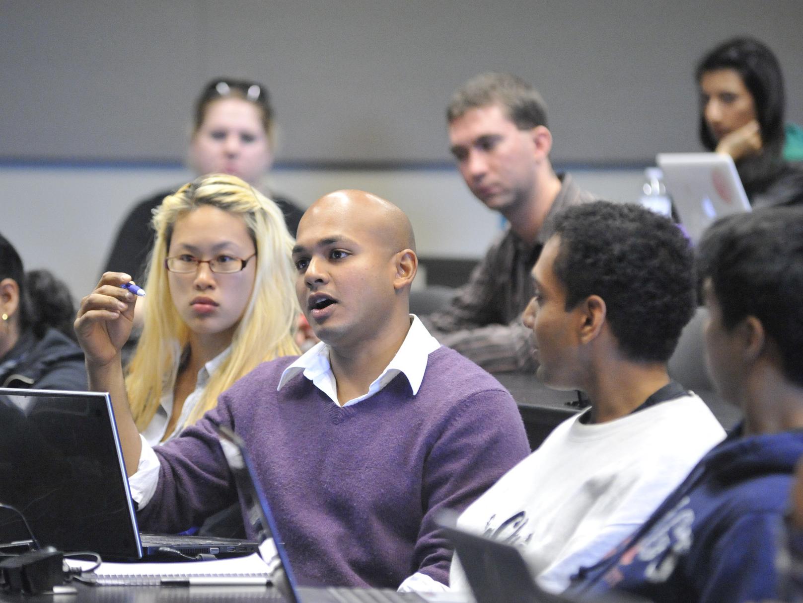 Students in discussion in a lecture hall