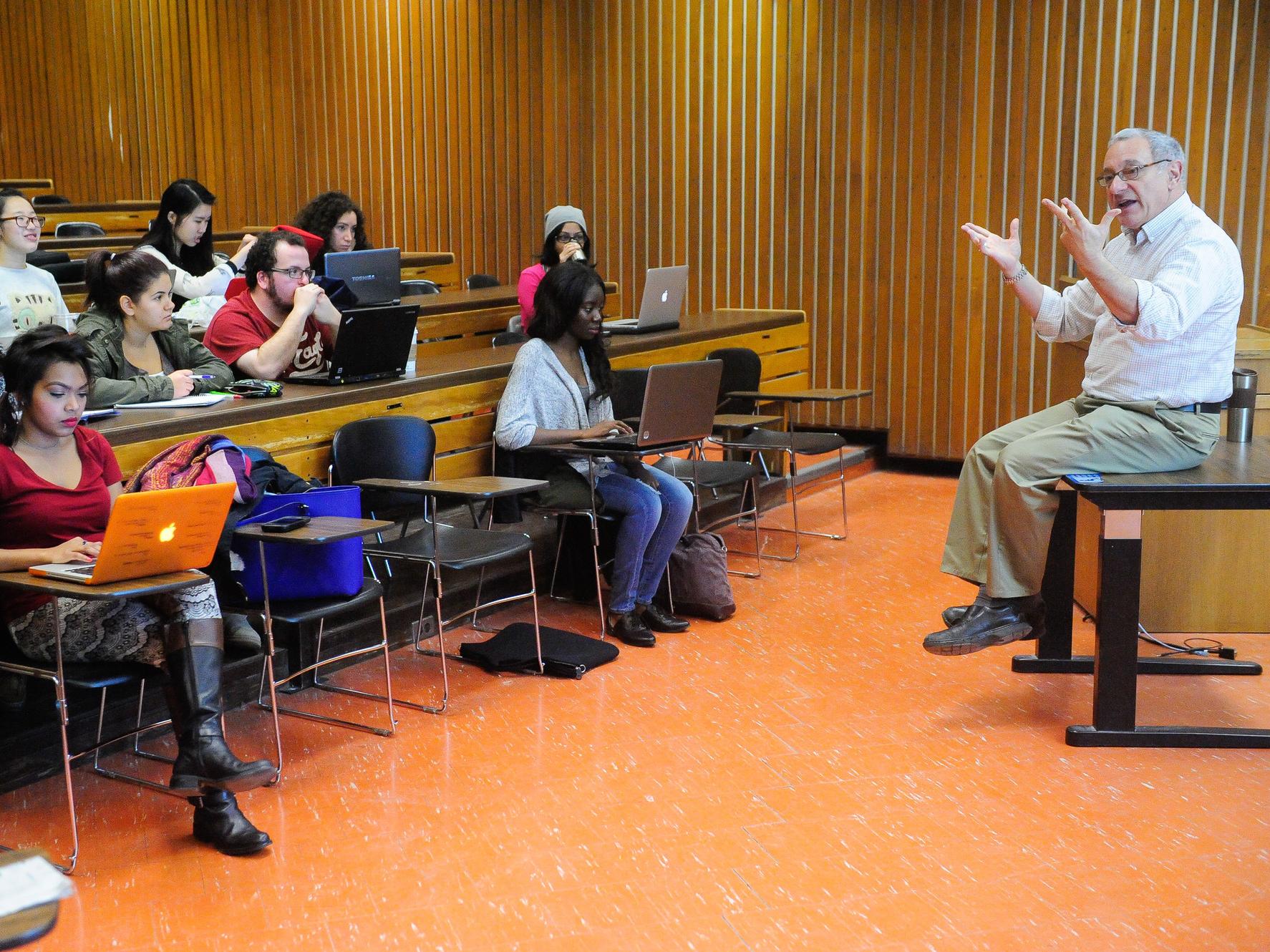 A professor teaching a group of students in a lecture hall