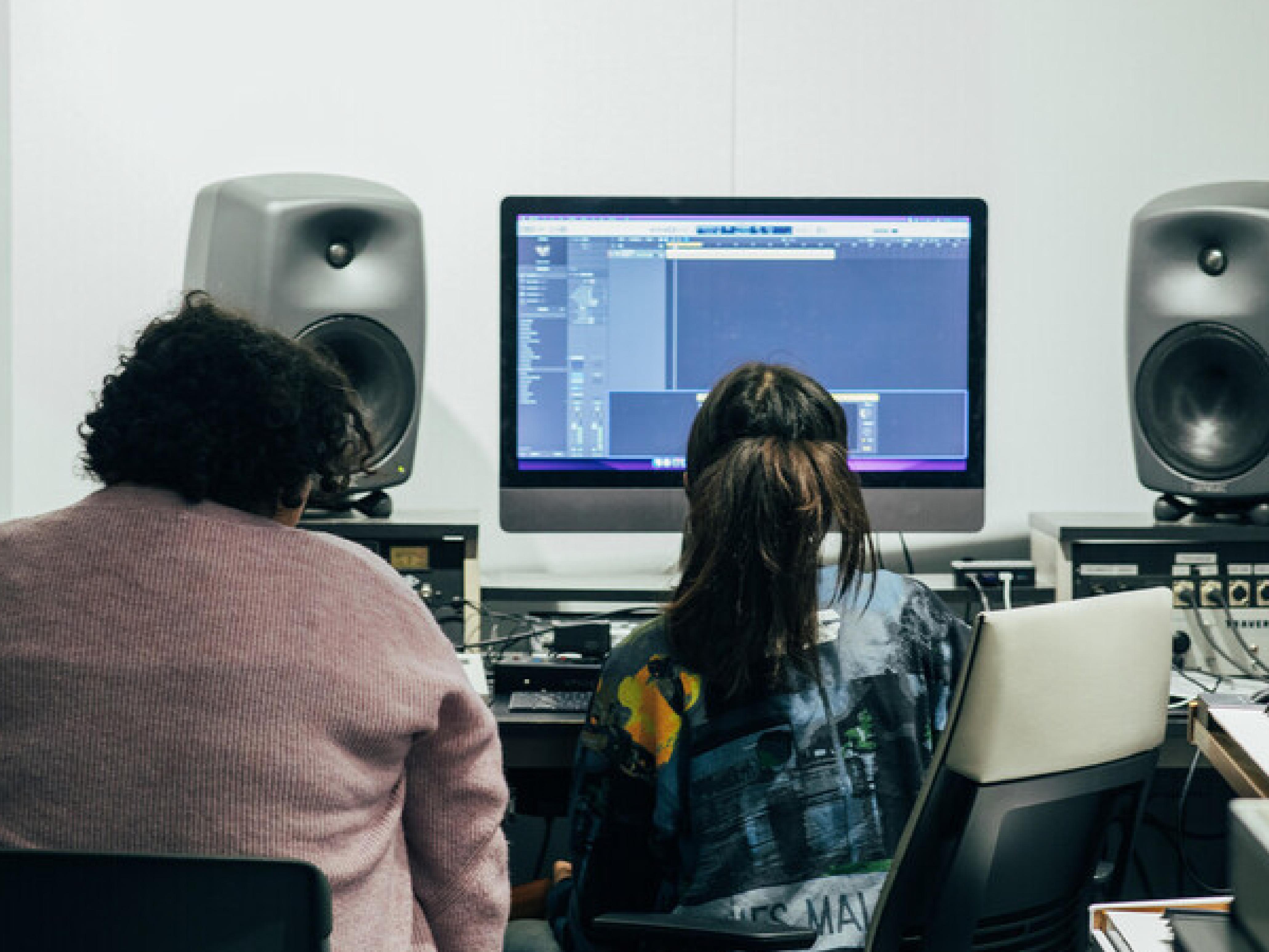 Students producing music at a studio 