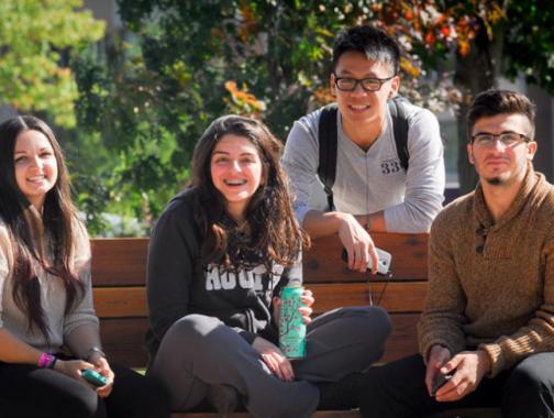 students on a bench outdoors