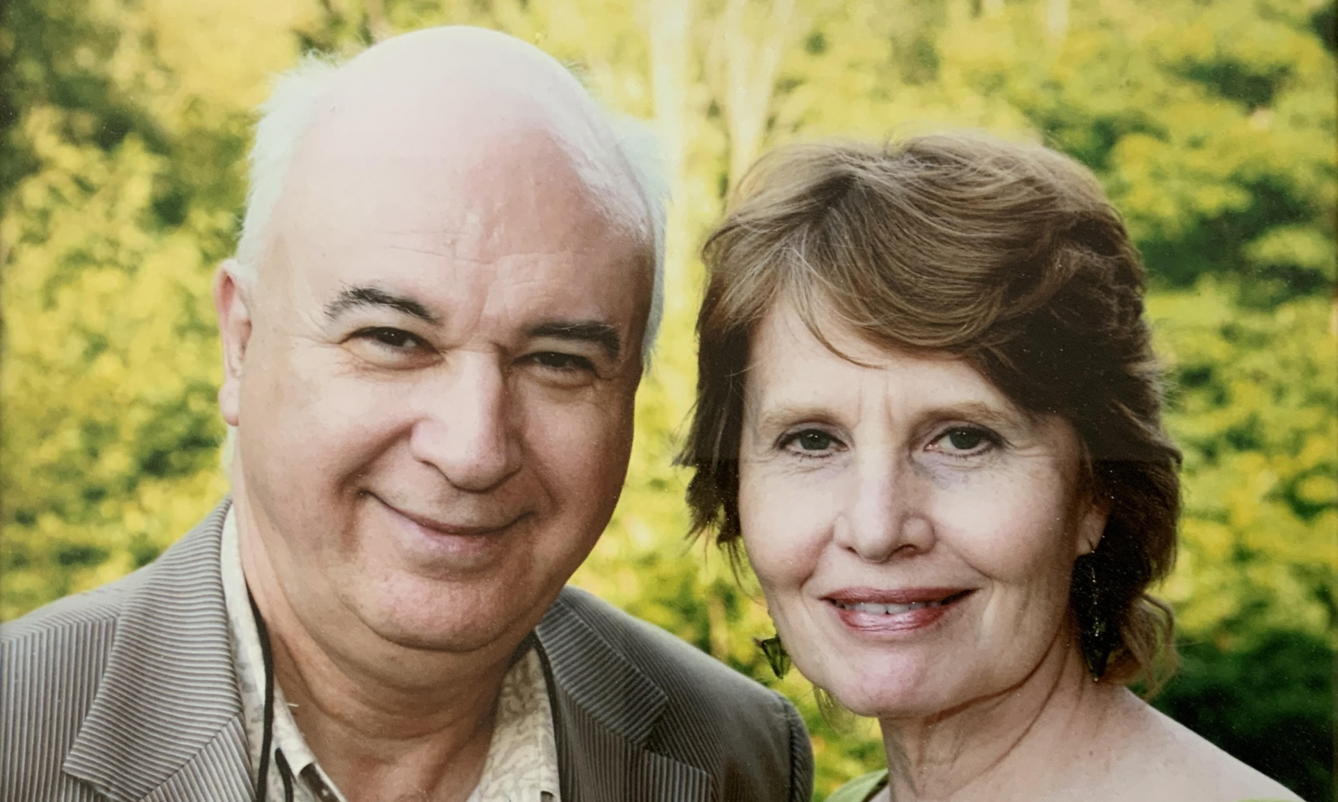 Stefan and Janice Sierakowski look at the camera with greenery behind them