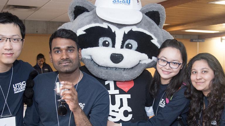 Student volunteers posing with UTSC Mascot Rex the Raccoon at UTSC Alumni Reunion
