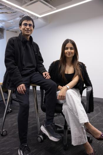 Two people sitting on high stools in formal wear