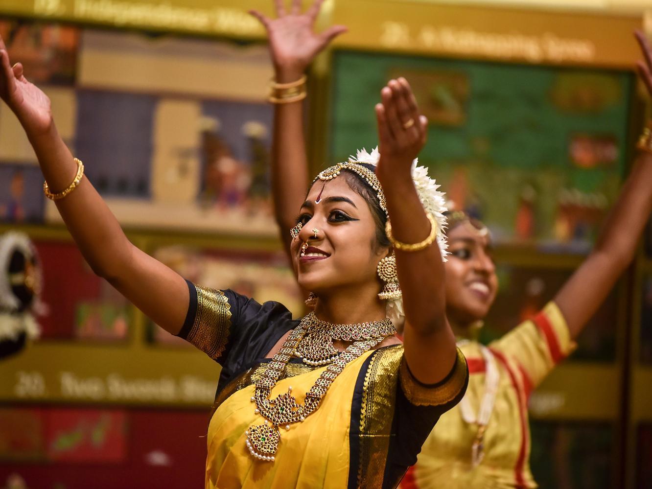 Dancers in colourful ceremonial Tamil costume perform at UTSC