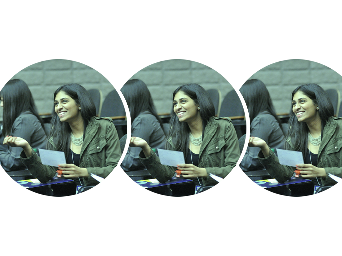 Three circles overlapping horizontally, with the same picture of a girl sitting and smiling at a job fair with a green tint over the image