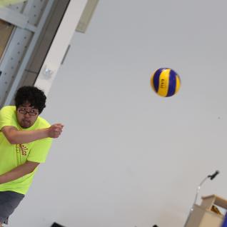 ball in the air as a staff memeber volleys
