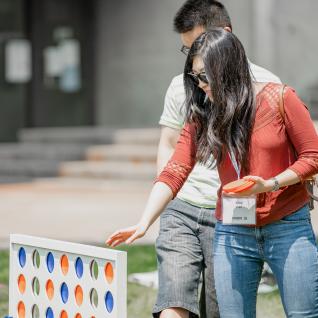 an alum plays giant checkers