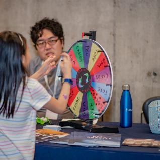 a young girl tries spin the wheel