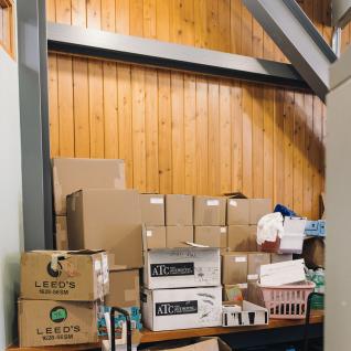 SCSU office with brown boxes of food stacked against the wall