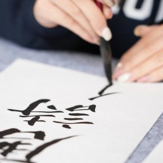 Student writing in calligraphy