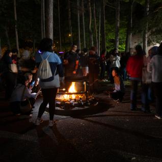 Attendees around a campfire