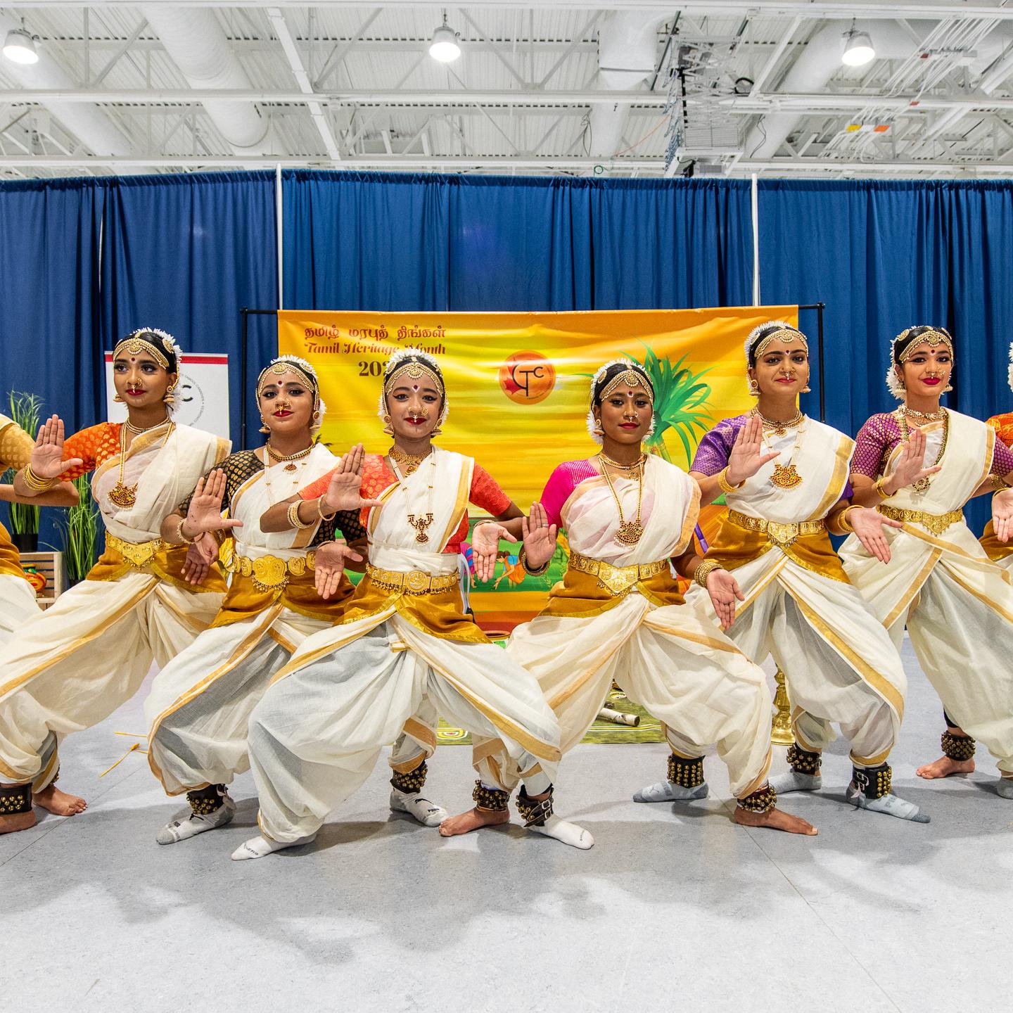 Group of dancers in tranditional outfits at Tamil Heritage Month event