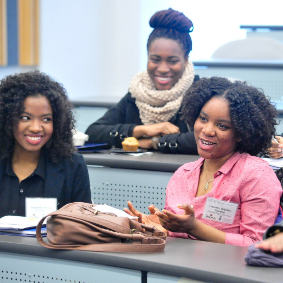 three Black female students in class, smiling