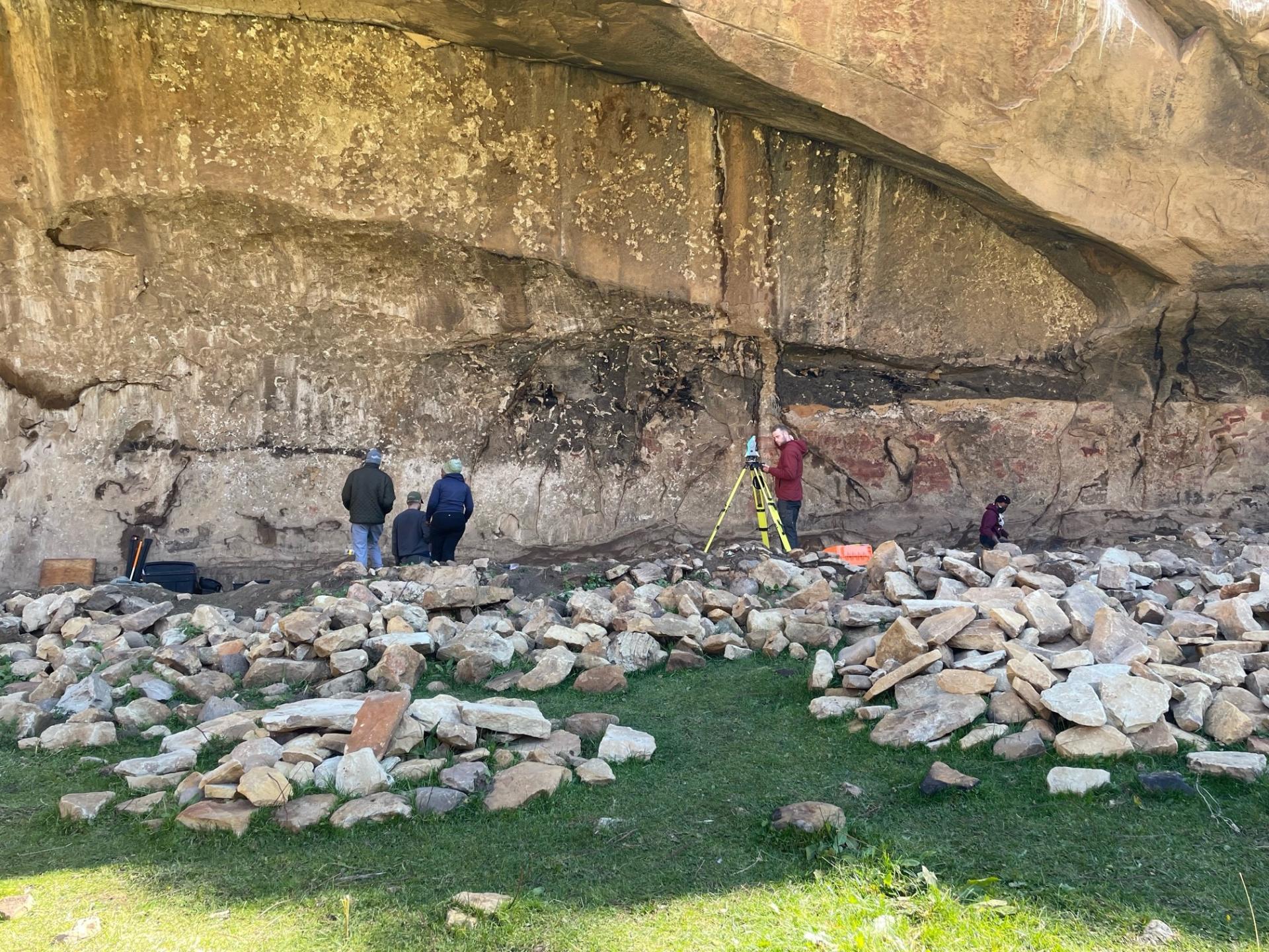 Archaologists surveying in the rock shelter of Ha Soloja, Lesotho
