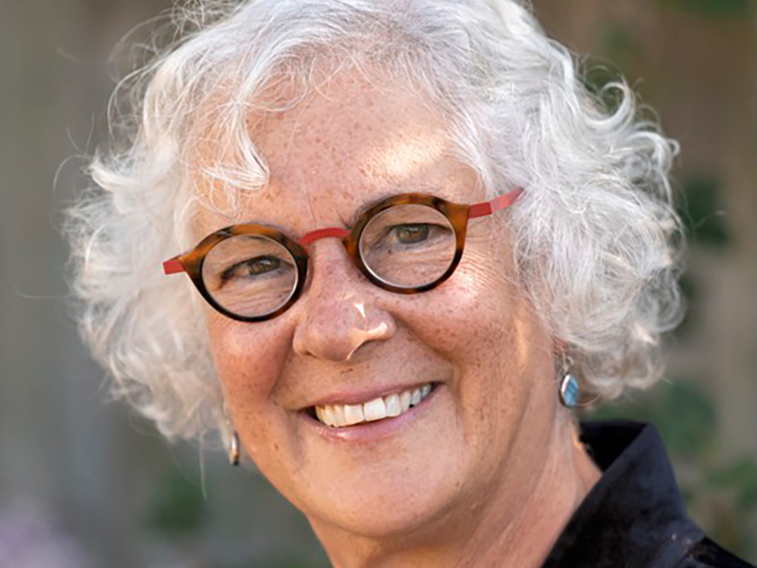 Dr. Lila Abu-Lughod, a woman with white hair and glasses smiling