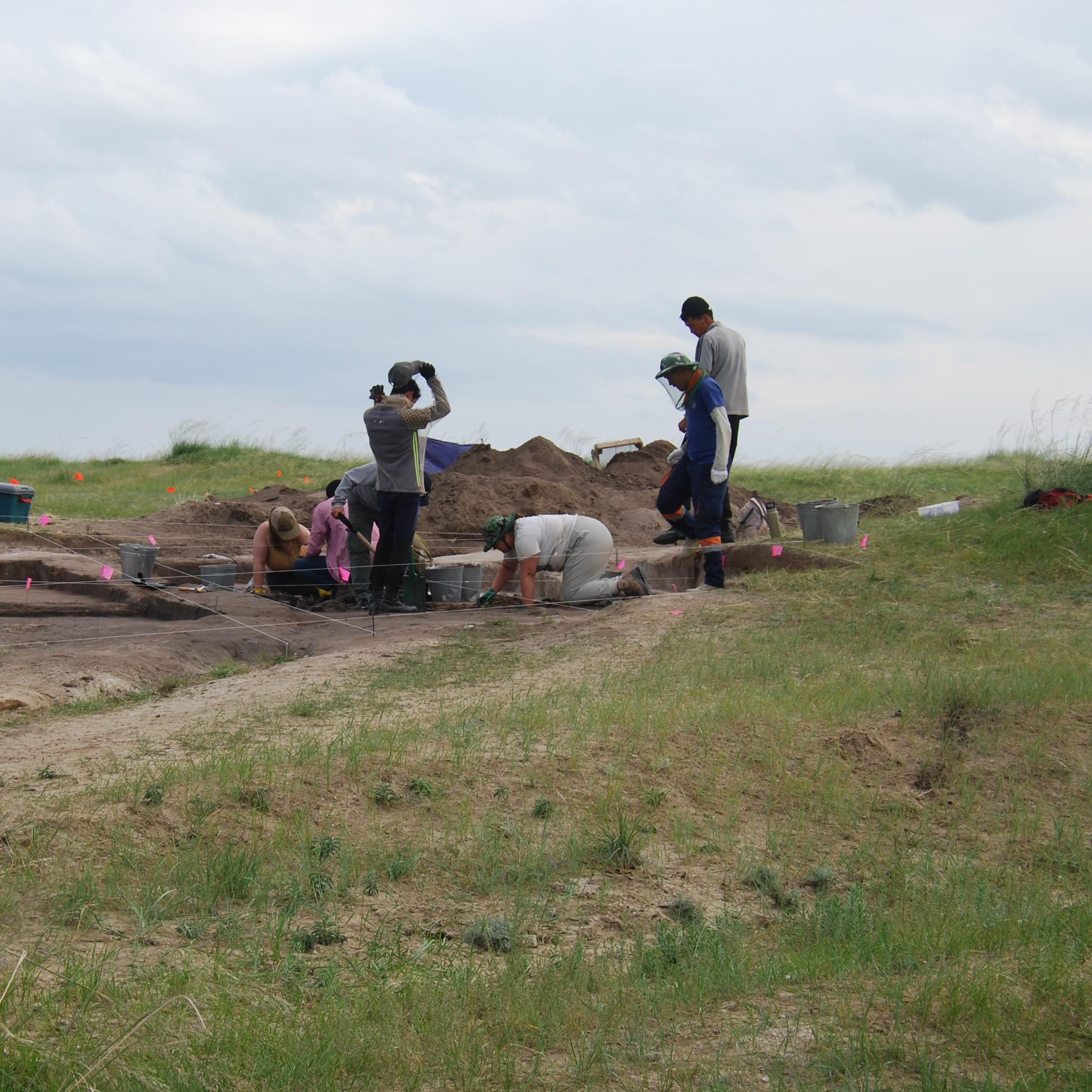 Archaeologists excavating around a burial site on the Gobi Steppe.