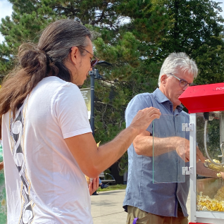 Prof. Schillaci and Prof. Furui serving popcorn