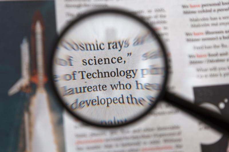magnifying glass on a newspaper