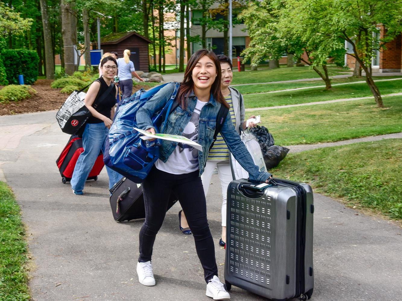 UTSC students with suitcases