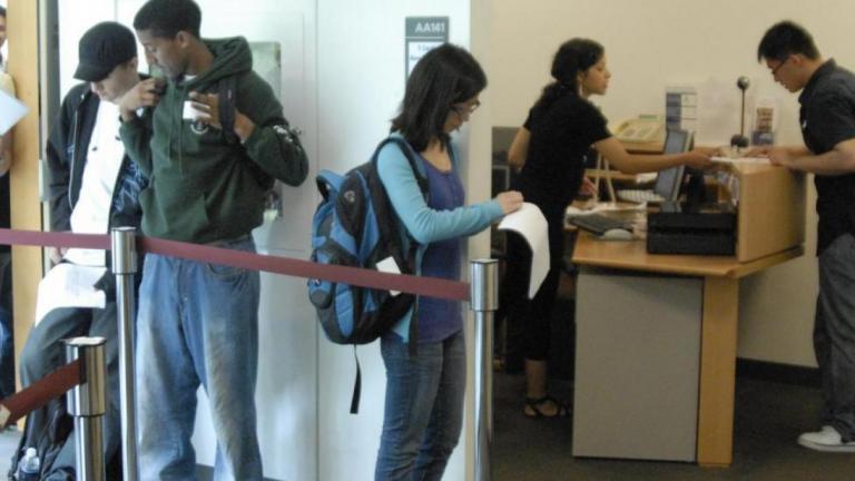students waiting in a line for help desk