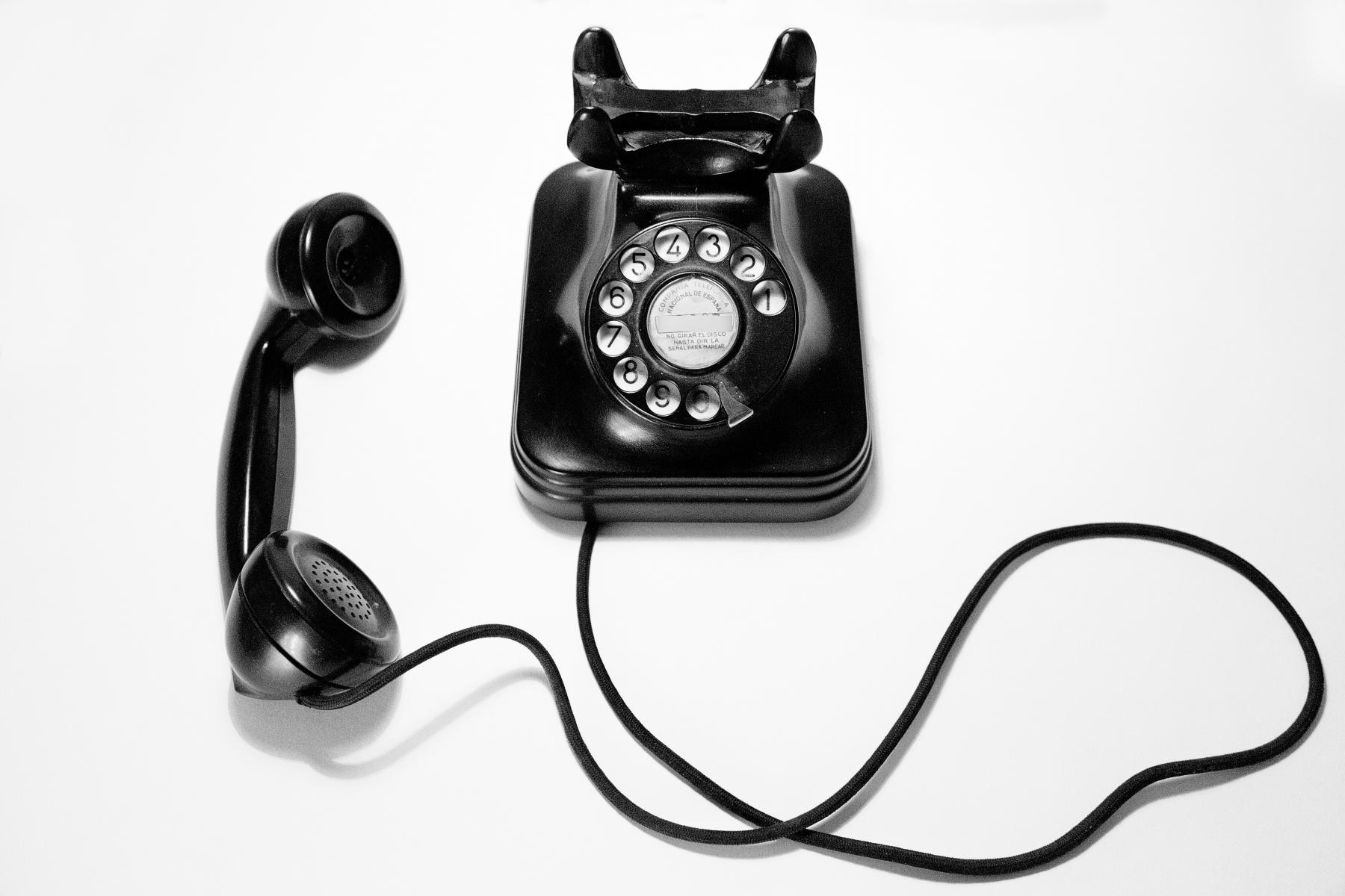 photo of a vintage dial telephone on a white background