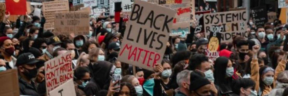 Photo by Tony Zhen on Upsplash. Large Black Lives Matter protest with handpainted signs.