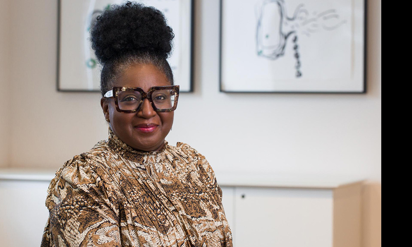 Professor Notisha Massaquoi, a black woman in a gold-coloured blouse with stylish glasses