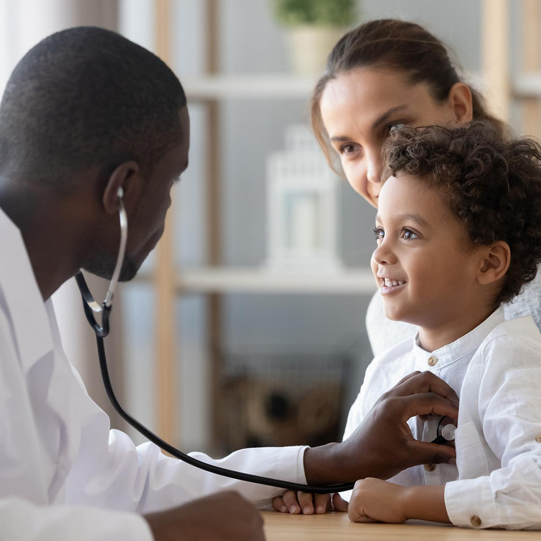 A Black doctor examining a baby