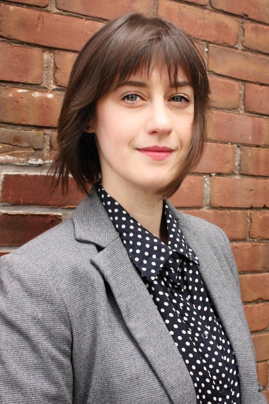 Jessica Bytautas, a white woman with brown hair wearing a grey blazer