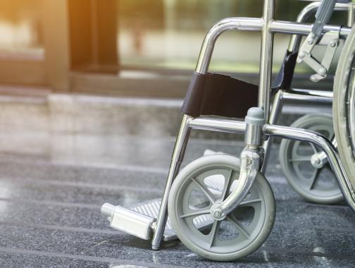 An empty wheelchair sitting on a polished floor