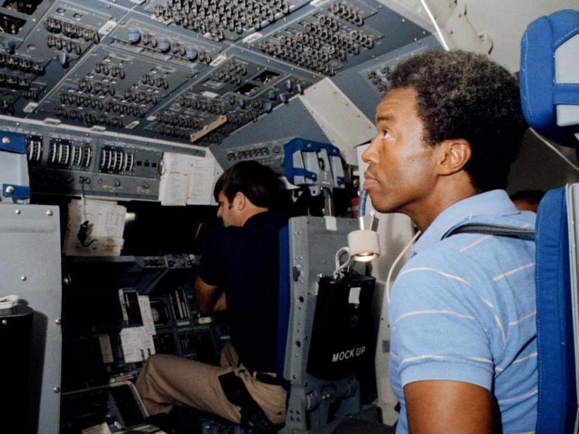 A Black astronaut inside of a space vehicle