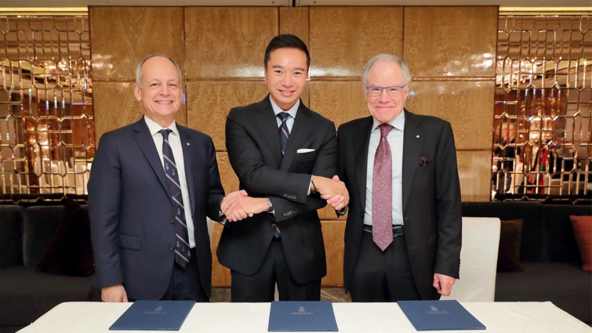 Tenniel Chu shakes hands with U of T President Meric Gertler and past principal of U of T Scarborough, Bruce Kidd