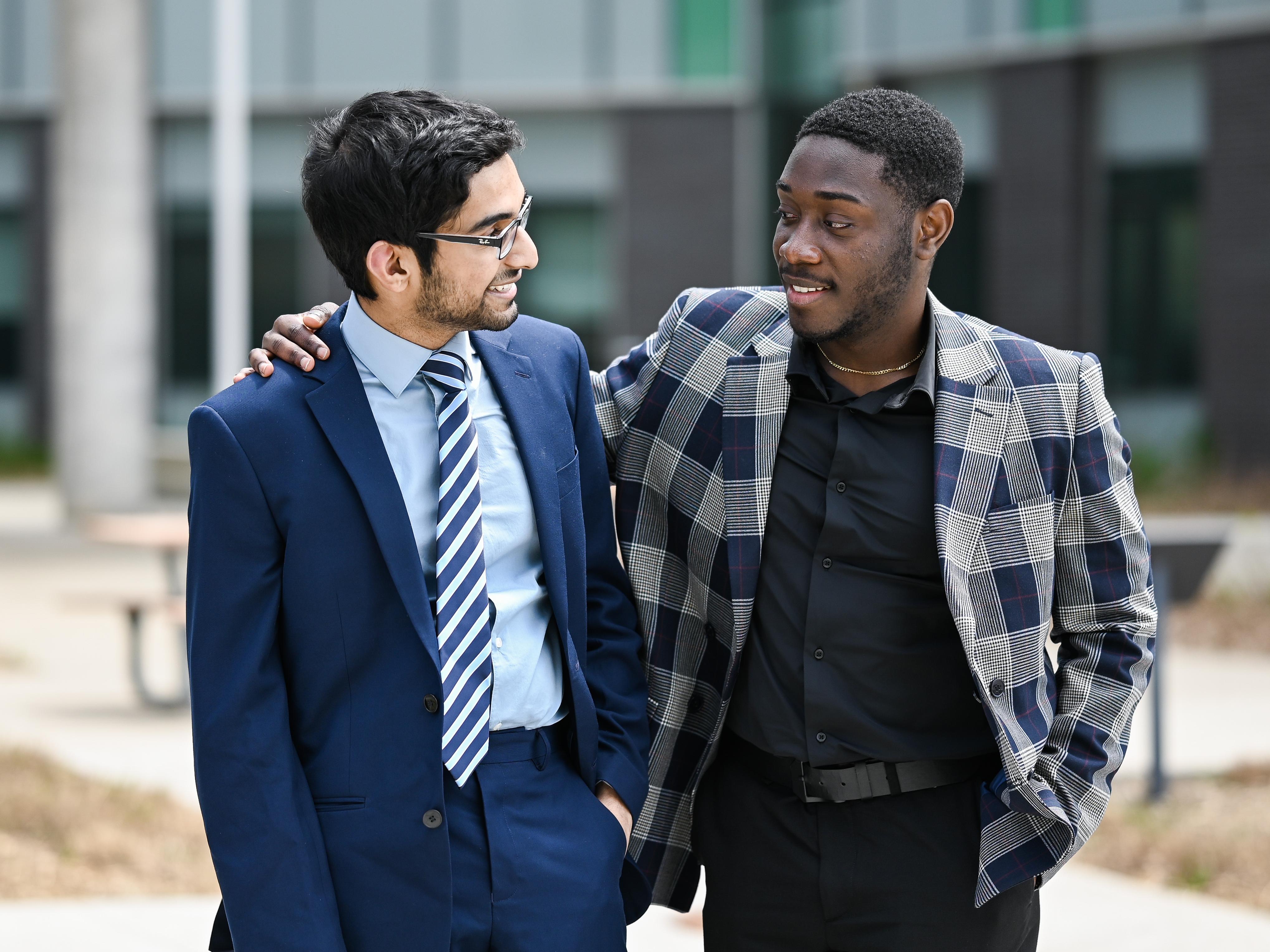 Management students Elvis and Nabeen hanging out on campus.