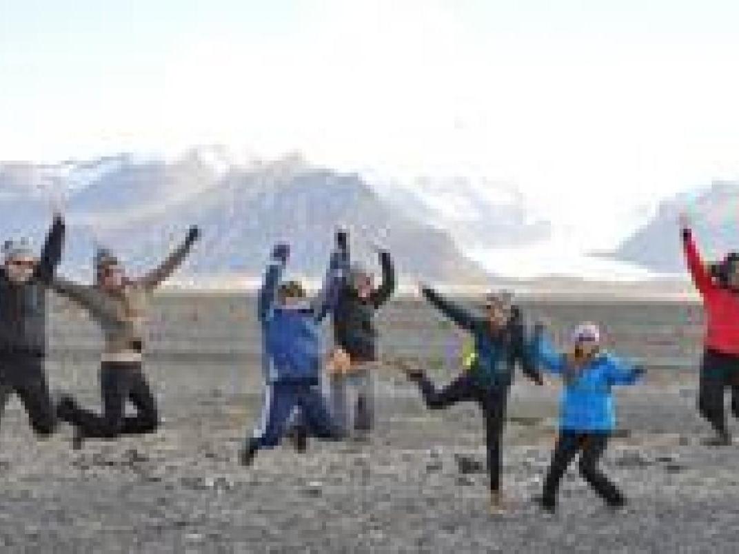 people jumping in front of an icelandic mountain