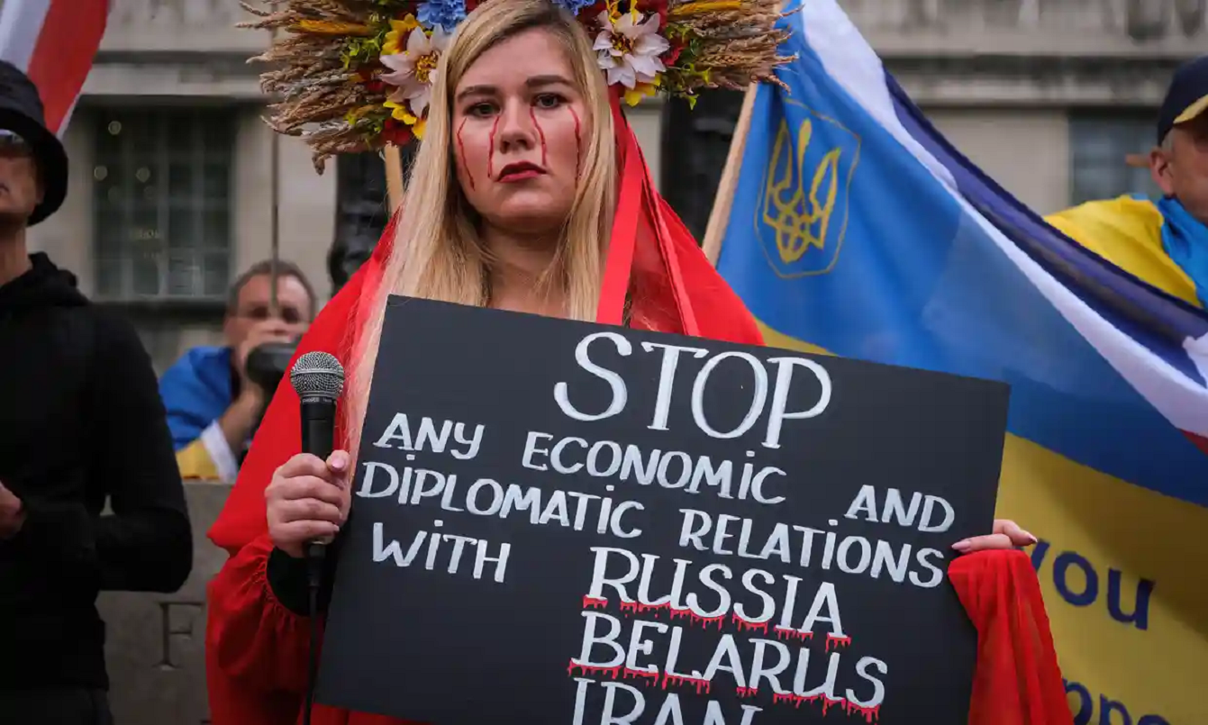 A protester in London holds up a sign asking to stop economic and diplomatic relations with Russia, Belarus and Iran Photograph: Jasmine Leung/SOPA Images/Shutterstock