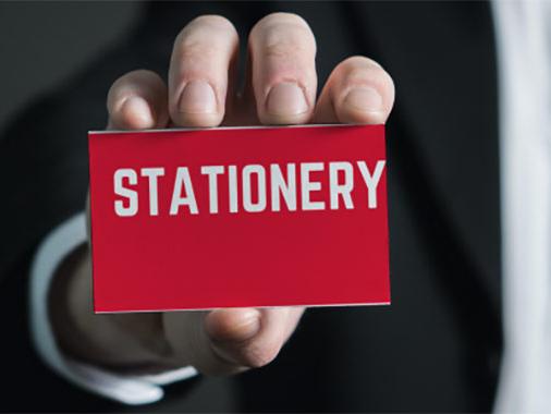 person holding red stationary card