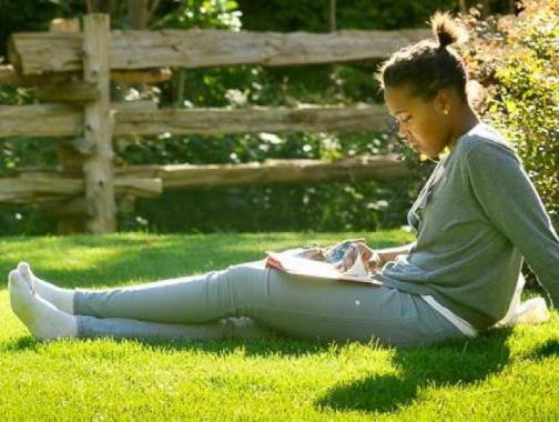 woman reading on the grass