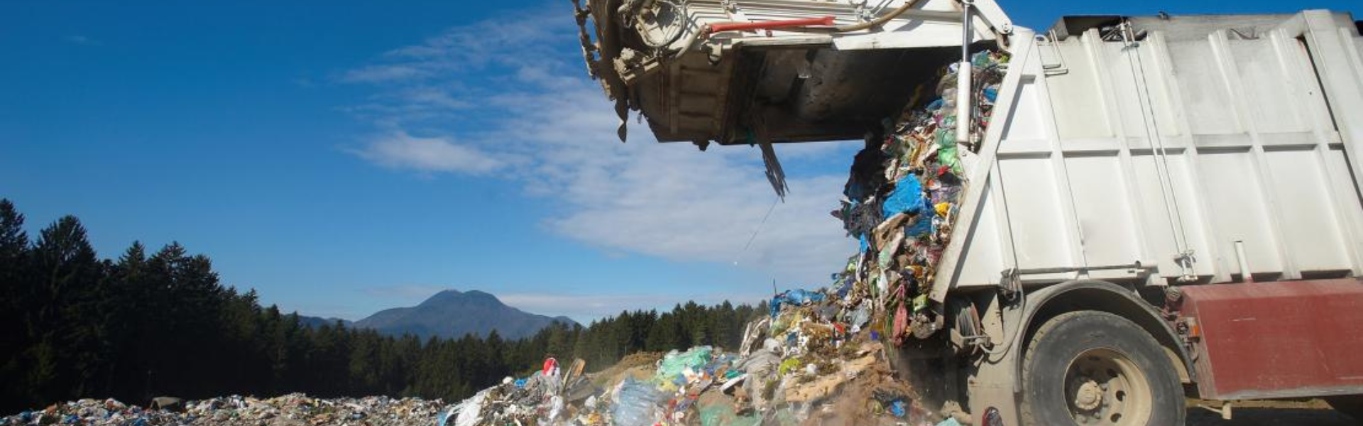 Photo of a garbage truck dumping garbage in a landfill
